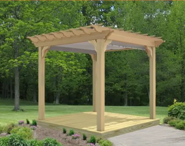 An 8x8 flat roof wood pergola made of light-colored pine sits on a treated pine deck in a green backyard setting. A light-colored single-track canopy is partially extended beneath the pergola's rafters, providing shade.