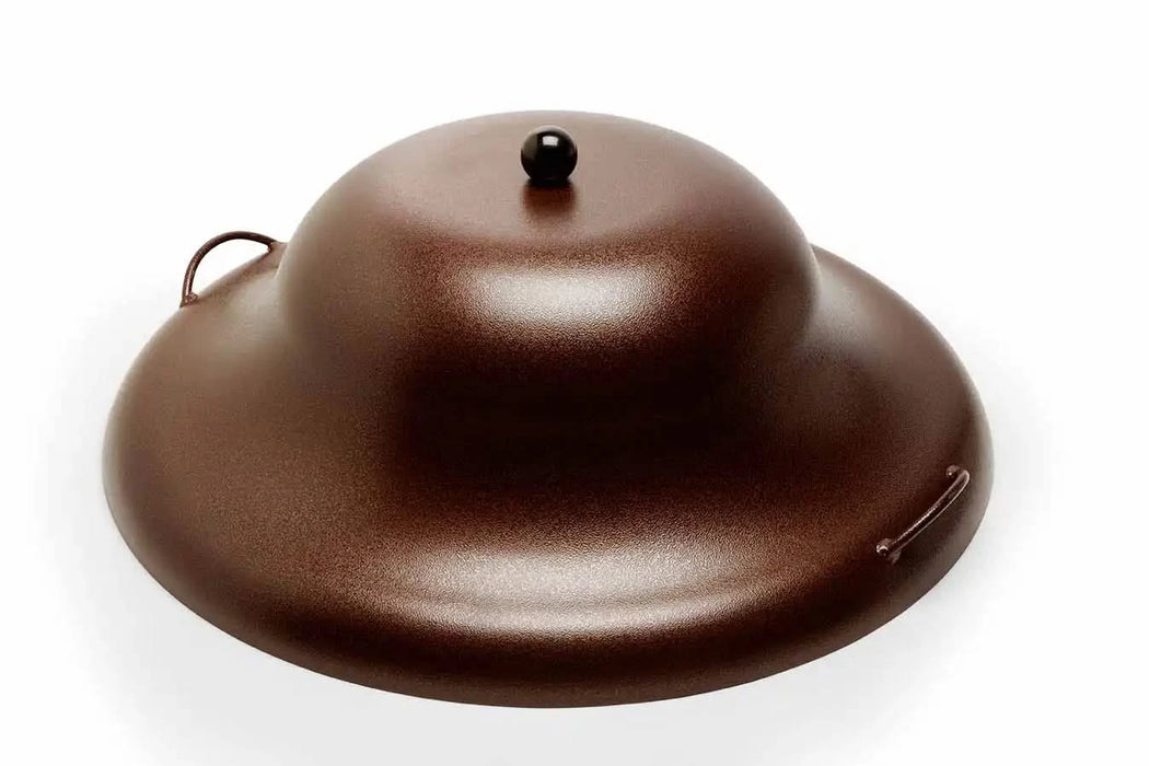A copper-colored aluminum fire pit cover with two handles and a ball finial on top. The cover is round and has a domed lid. It is designed to protect a fire pit from the elements.