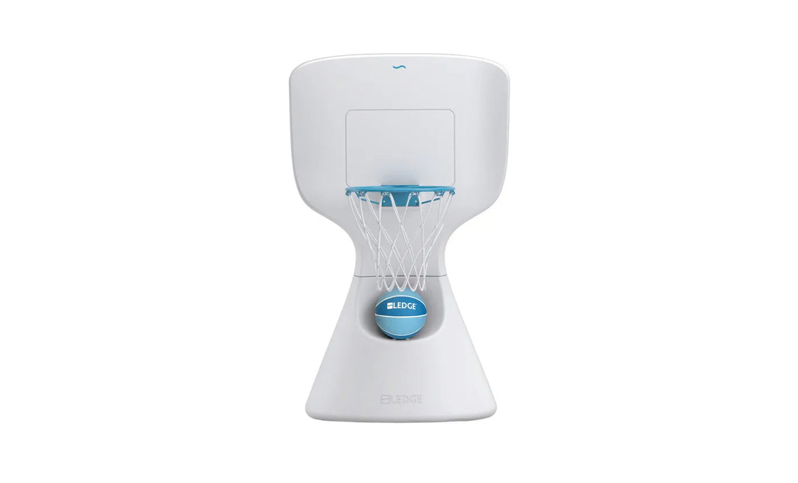 A Ledge Lounger Hoopstr poolside basketball hoop is isolated against a stark white background. The hoop is primarily white with a blue rim and a white net. A small, light blue basketball with the word "LEDGE" printed on it in white is nestled in the base of the hoop structure. The product is centrally positioned in the frame, allowing for a clear view of its design and features.