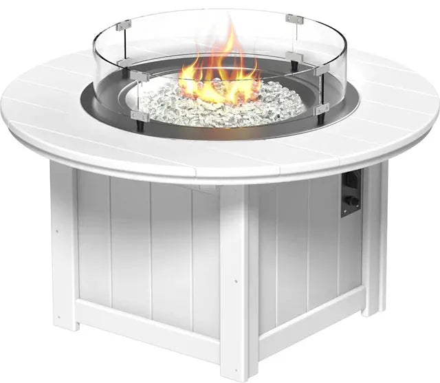 A close-up of a LuxCraft Lumin 46" White Round Fire Pit with a glass wind guard. The fire pit is ignited, showcasing white fire glass within."