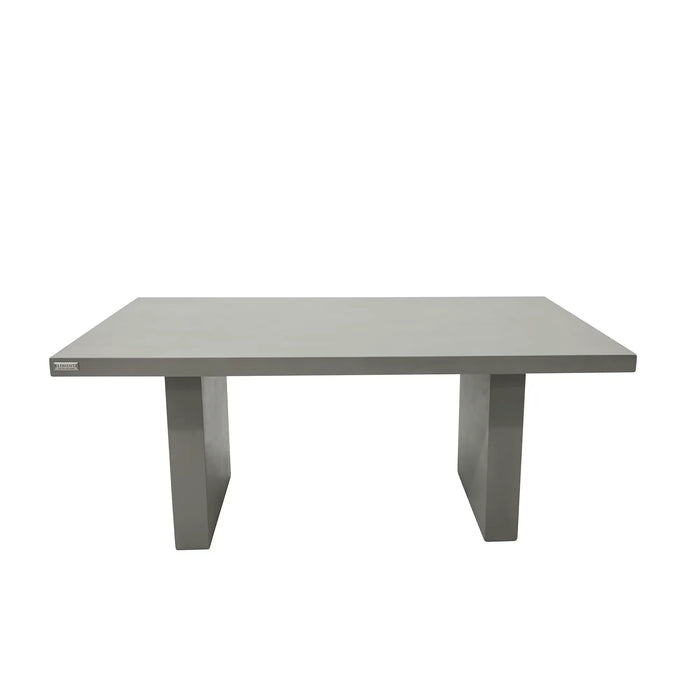 A solid, rectangular outdoor dining table made of gray concrete. It features a thick tabletop and two sturdy, block-like pedestal legs.