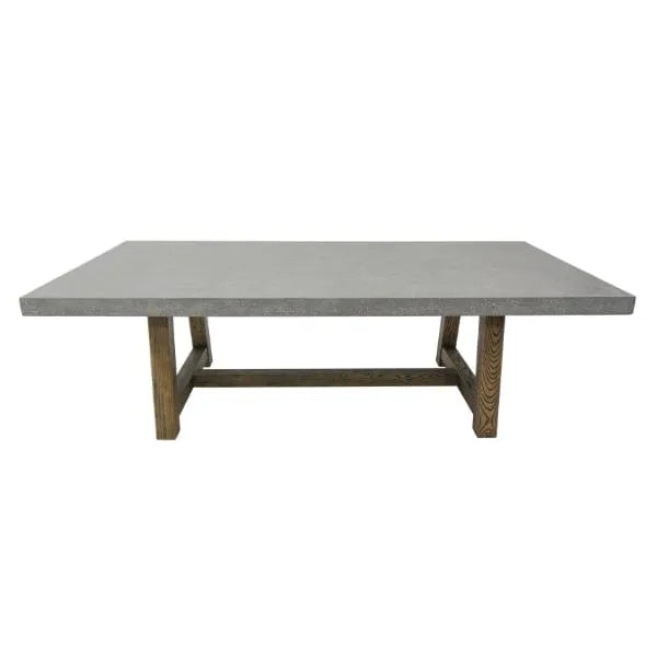 A modern rectangular dining table featuring a smooth, light gray concrete tabletop and sturdy, light brown wooden trestle-style legs.