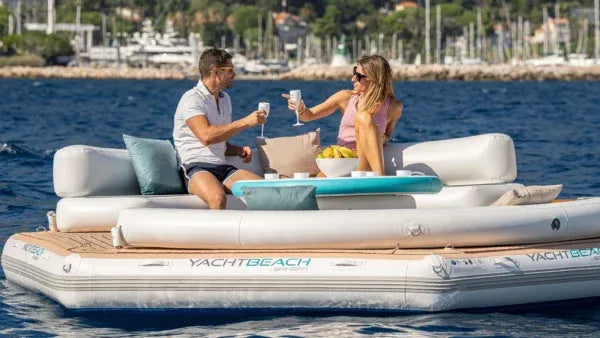 Two people on a YachtBeach inflatable yacht platform in the water.