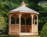 A wooden octagonal gazebo with a shingled roof, decorative cupola, and lattice detailing on the walls.