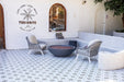 Outdoor seating area with a fire pit and chairs, featuring the TUI-HAVRE logo on the wall.