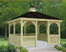 10 ft x 10 ft wooden gazebo with a peaked roof and decorative latticework. The gazebo stands on a concrete base surrounded by greenery.