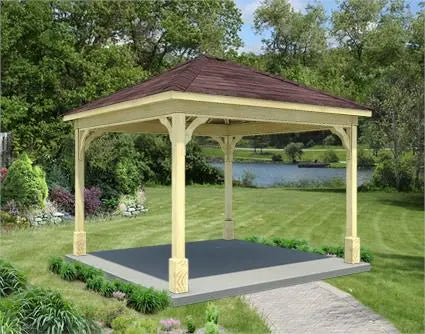 A cedar wood gazebo with a gabled roof and a concrete base. The gazebo is surrounded by lush greenery and a lake is visible in the background.