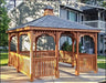 A large, cedar rectangle gazebo with a gray roof and cedar walls. The gazebo has a decorative cupola at the top and is surrounded by a wooden railing.