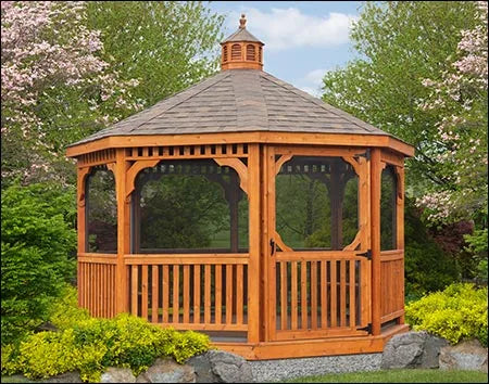 A wooden octagonal gazebo with a shingled roof, decorative cupola, and screened-in walls. The gazebo features lattice detailing and is surrounded by greenery.