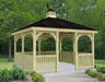 12 x 12 wooden gazebo with a peaked roof and decorative latticework. The gazebo stands on a concrete base surrounded by greenery.