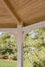 White vinyl octagon gazebo with a sloped roof, featuring decorative roof trim and exposed wooden rafters.