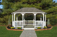 White vinyl octagon gazebo kit, perfect for outdoor entertaining in backyard next to green grass and trees