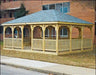 20 x 40 fifthroom wooden gazebo with a peaked roof and decorative latticework. The gazebo stands on a concrete base surrounded by greenery.