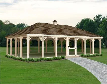 A large 20 ft by 40 ft rectangular screened gazebo with a peaked roof and decorative latticework. The gazebo has a double door with a small window and is surrounded by lush greenery.