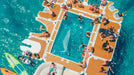 People relaxing on a large inflatable jet ski dock in the ocean.