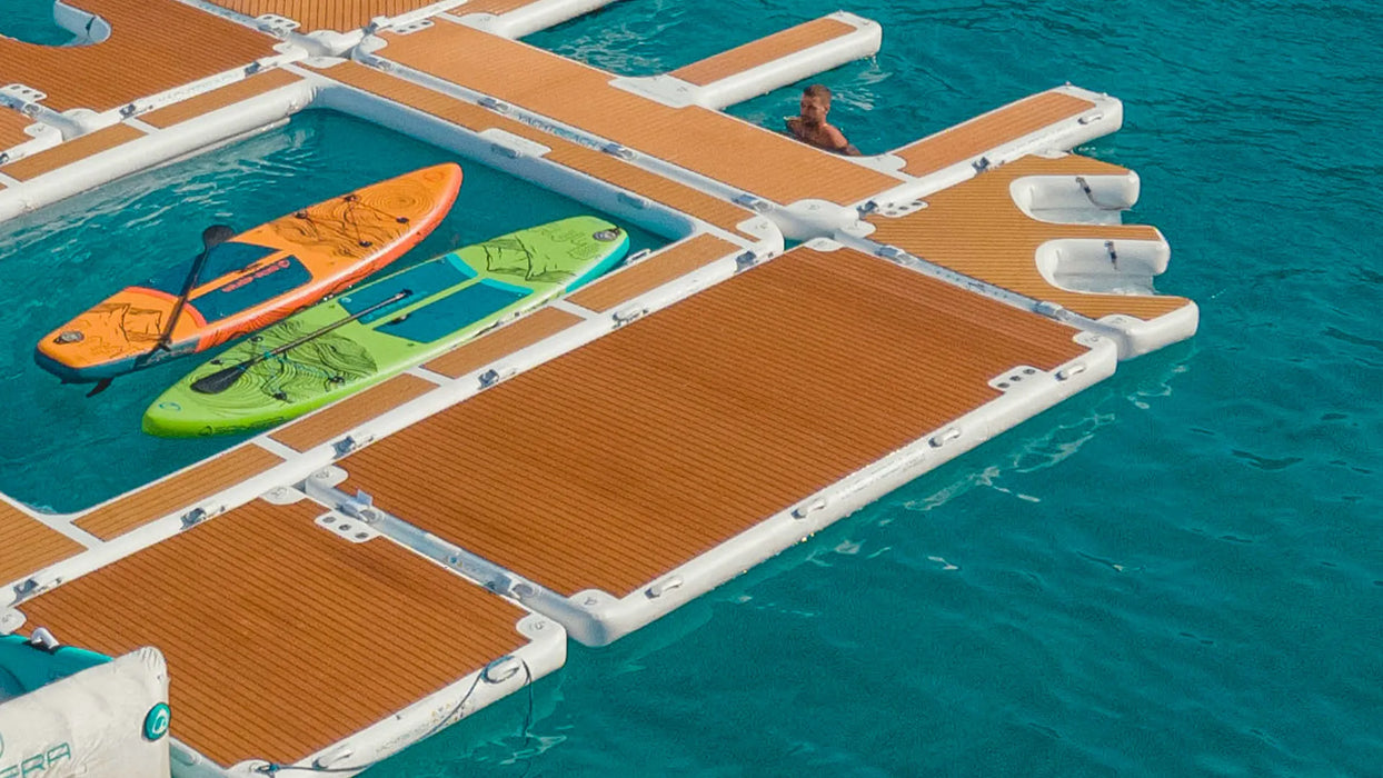 Floating dock with kayaks on a clear blue water background
