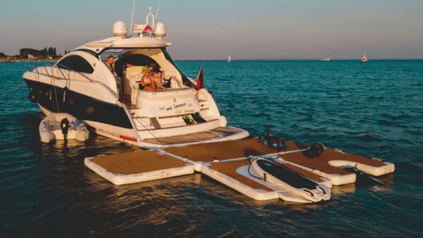 Luxury yacht with a floating platform on a calm blue sea