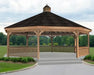 A large, wooden dodecagon gazebo with a shingled roof and a decorative cupola. The gazebo features a spacious interior with open latticework walls, a surrounding deck, and steps leading up to the entrance.