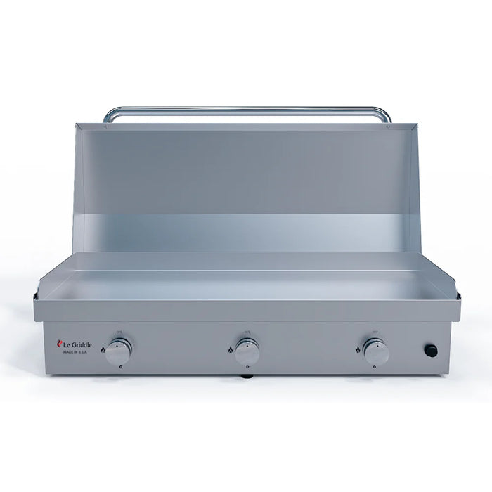 A stainless steel Le Griddle gas griddle with a matching stainless steel lid. The lid is open, revealing the griddle's cooking surface.