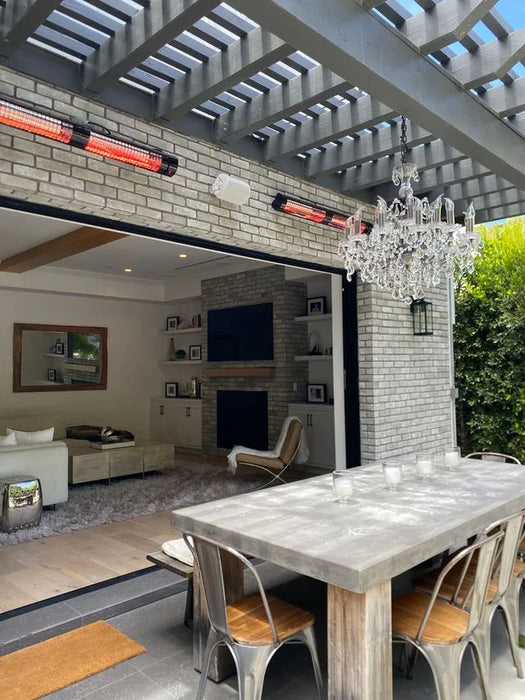 Modern outdoor living space with dining table and chairs, open to a living room and patio  heater