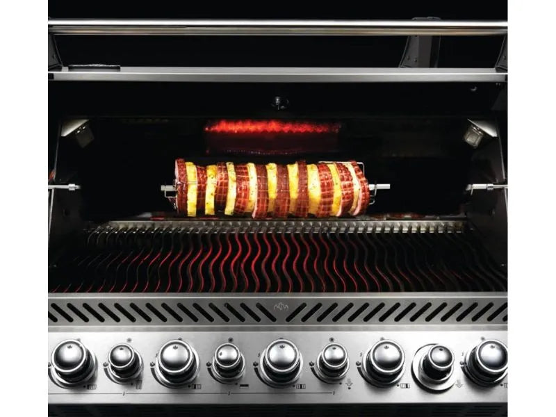 A stainless steel gas grill with a rotisserie cooking a skewer of meat and vegetables.