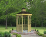 A large octagonal gazebo with a classic design. It features a shingled roof, decorative railings, and built-in benches. The gazebo is made of pressure-treated pine and is available in a variety of sizes.