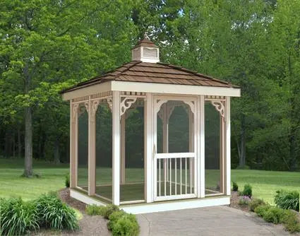 8' x 8' rectangular screened gazebo with a peaked roof and decorative latticework. The gazebo has a double door with a small window and is surrounded by lush greenery.