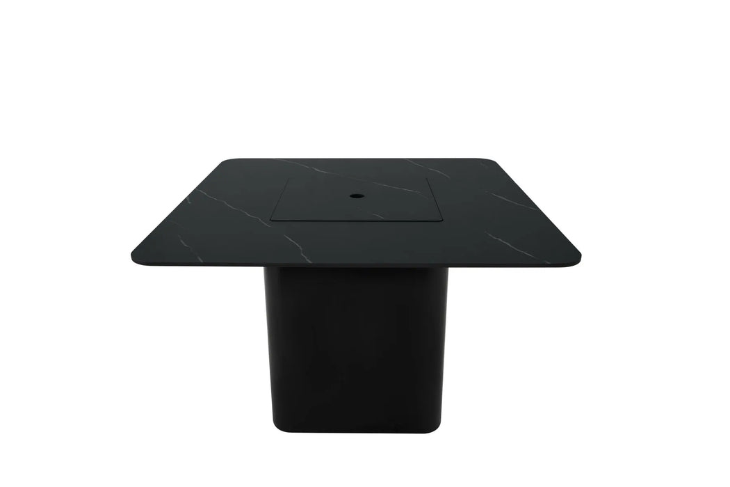 A square black fire pit table with a dark surface featuring subtle veining and a black base, shown from a top-down perspective. A square fire pit area is visible in the center. Isolated on a white background.