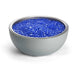 Blue glass decorative rocks in a white ceramic bowl