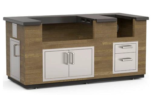 A modern outdoor kitchen island with a sleek, rectangular design. The island features a combination of stainless steel and warm wood accents, with built-in storage compartments, a cutting board, and space for a grill and side burner.