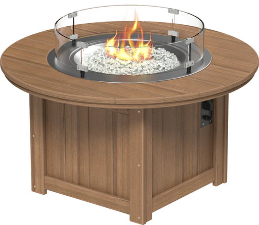 Brown, round fire pit table with a built-in propane tank storage compartment, glass wind guard, and push-button ignition.