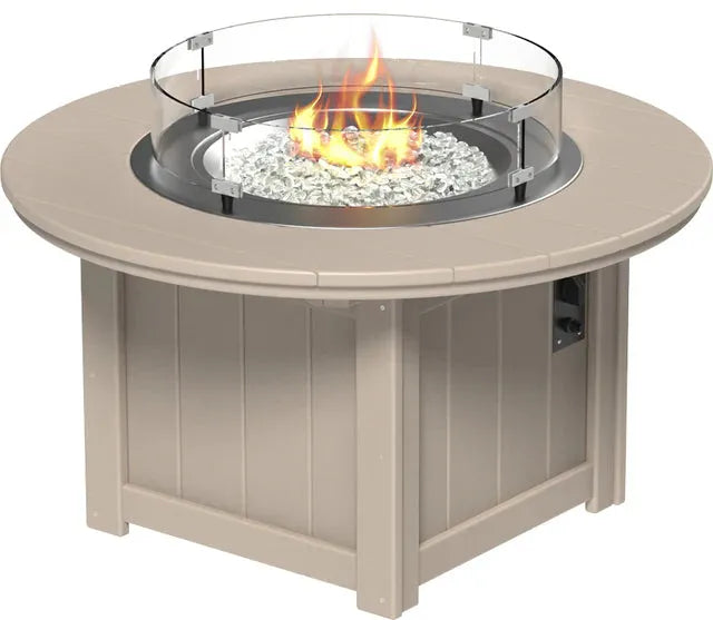 round fire pit table with a glass wind guard and a burning fire