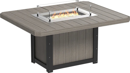 Square outdoor dining table made of weather-resistant material with a built-in fire pit and glass wind guard.