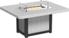 Square outdoor dining table made of weather-resistant grey material with a built-in fire pit and glass wind guard.