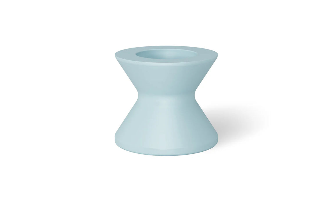 A mint green round poolside table with a wide base and a slightly tapered top.