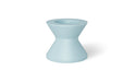 A mint green round poolside table with a wide base and a slightly tapered top.
