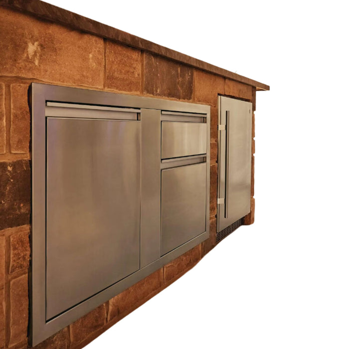  A stainless steel outdoor kitchen module with two refrigerator drawers and one freezer drawer. The module is built into a brick wall, with the drawers flush-mounted for a seamless look.