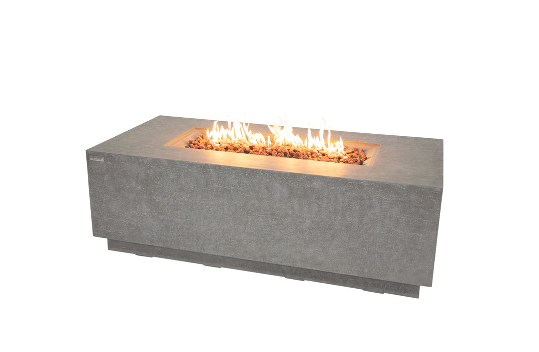 light grey high performance cast concrete fire table with yellow and orange fire lit on the pit