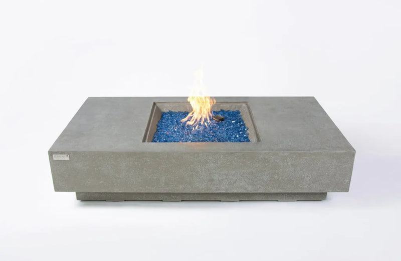 Rectangular outdoor fire pit table with blue fire glass visible, no visible enclosure, set against a white background.