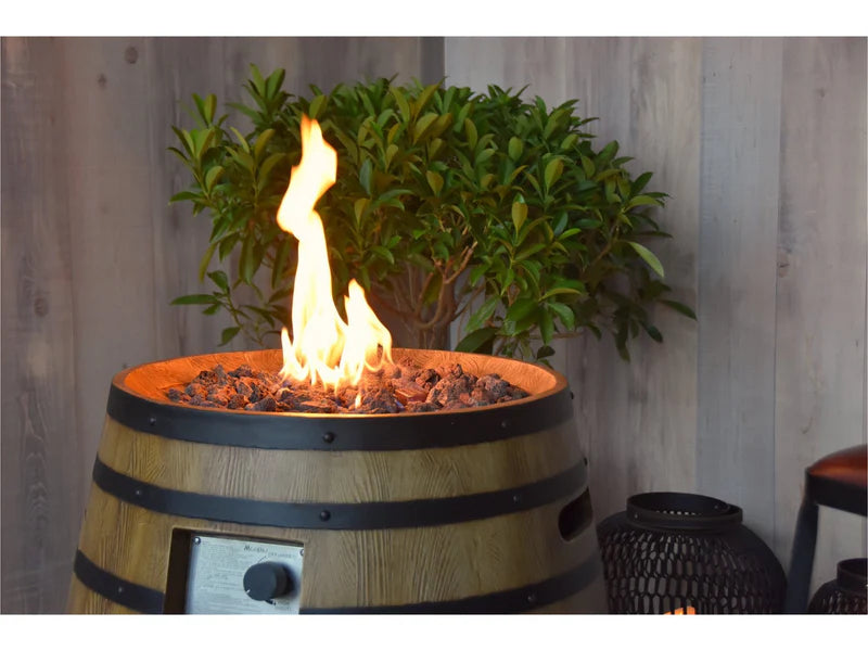 round fire column with fire pit lid on brown lava rocks