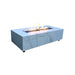 elementi rectangular fire pit with white marble counter top. rectangle fire pit is lit with yellow and orange flame 