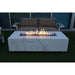 rectangular outdoor fire pit that is lit using blue fire glass in an outdoor patio setting