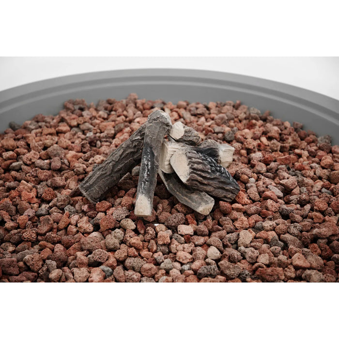 Stack of firewood on a bed of small stones with a white background
