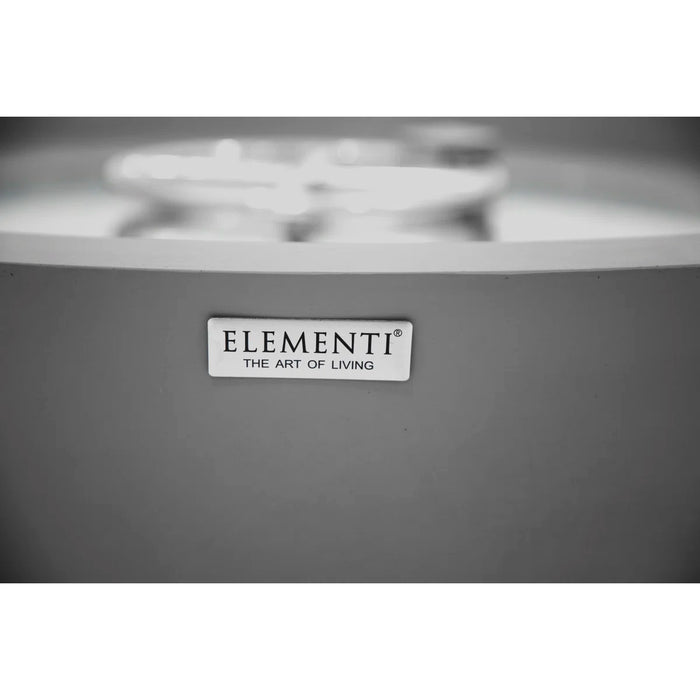 Gray appliance with 'Elementi' brand logo on a blurred background