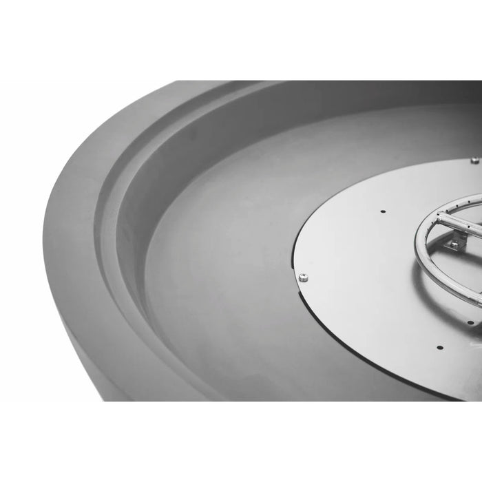Close-up of a metallic circular object with a central feature on a white background