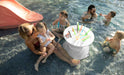 family in the pool with a in pool side table holding their drinks and snacks