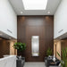 Modern interior with an adagio water feature, gray sofas, and plants.