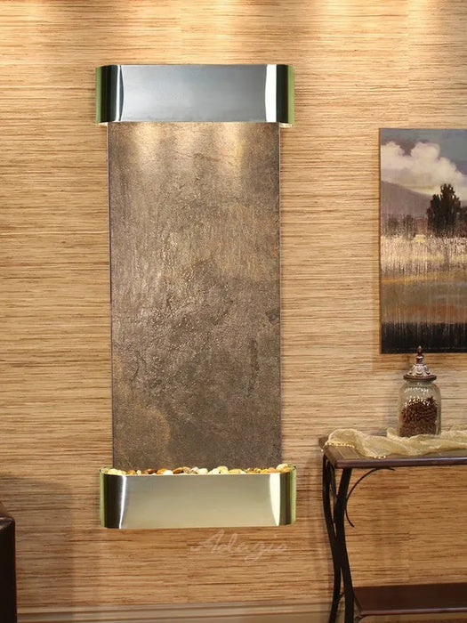 Wall mounted water feature by adagio with decorative elements in a room setting