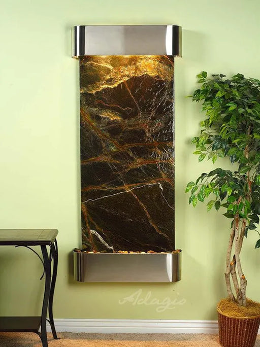 adagio water feature with a stainless steel trim and hood on a green marble slate
