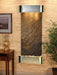 Decorative wall fountain by adagio water feature with metallic finish on a wooden wall